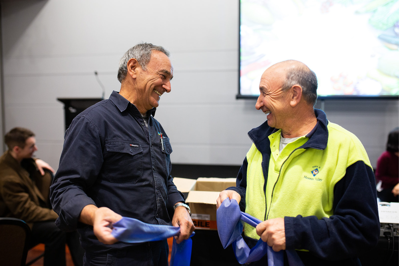 Image of two men speaking